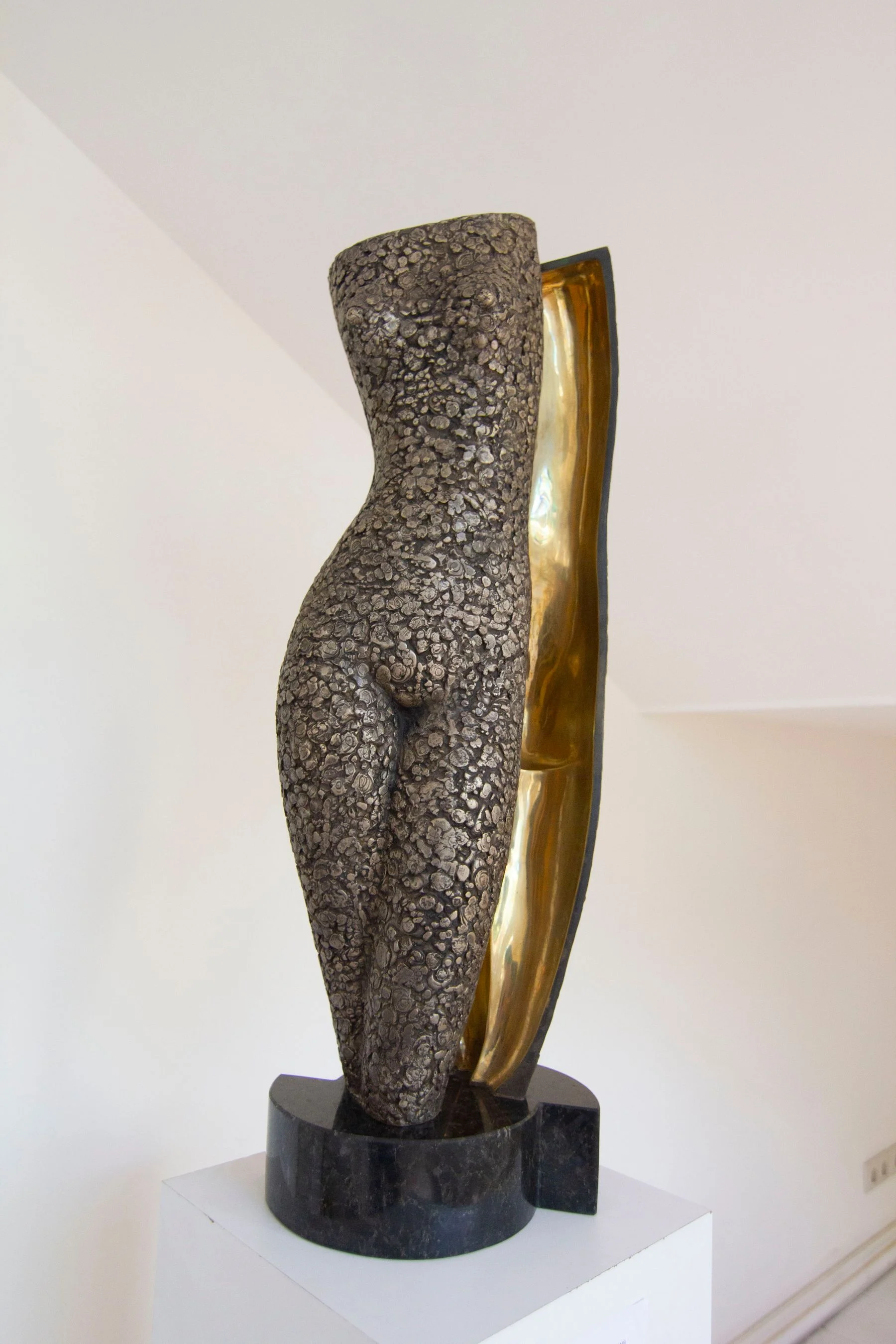 Modern torso sculpture in a gallery