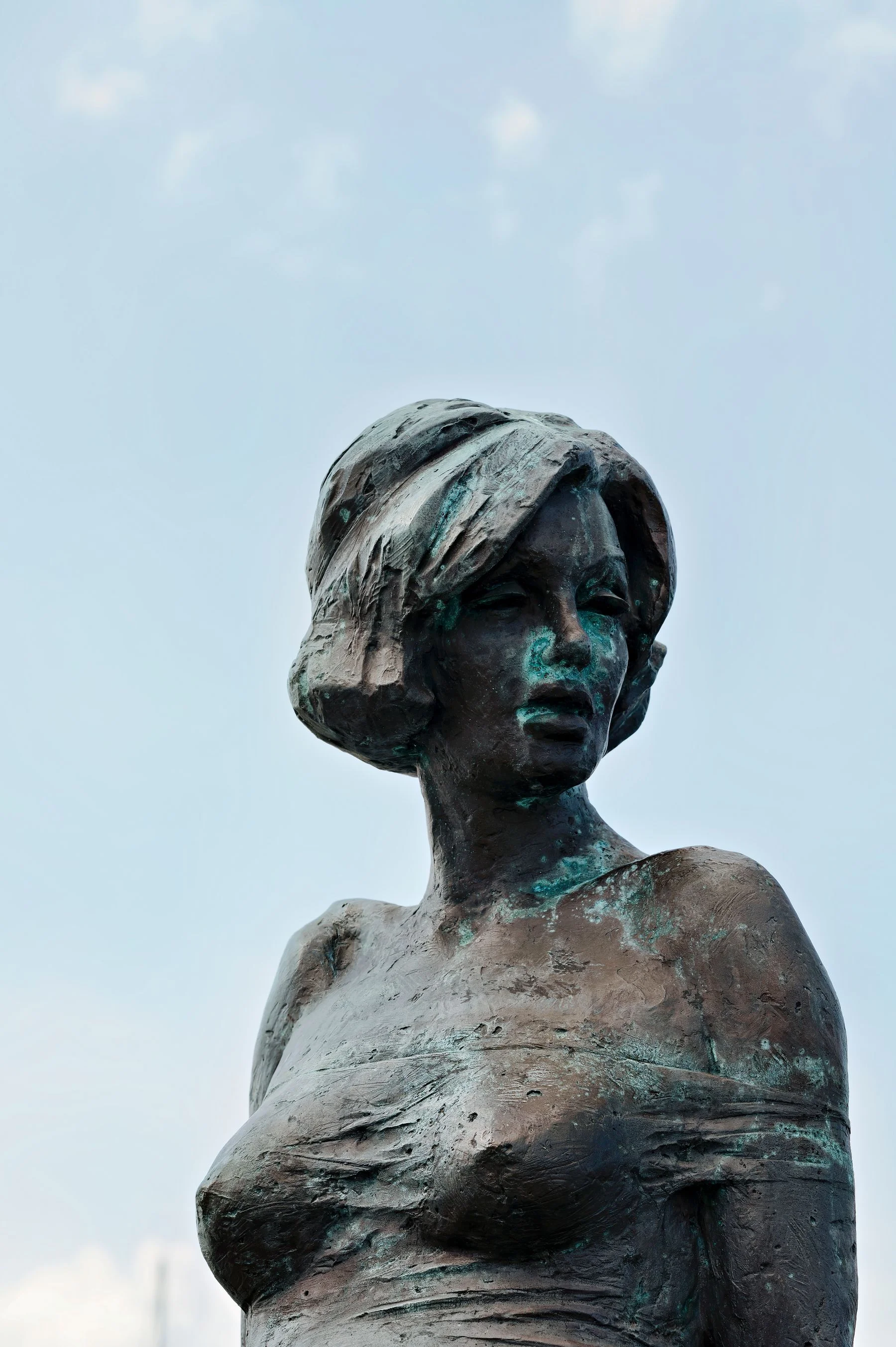 Weathered bronze head of a woman