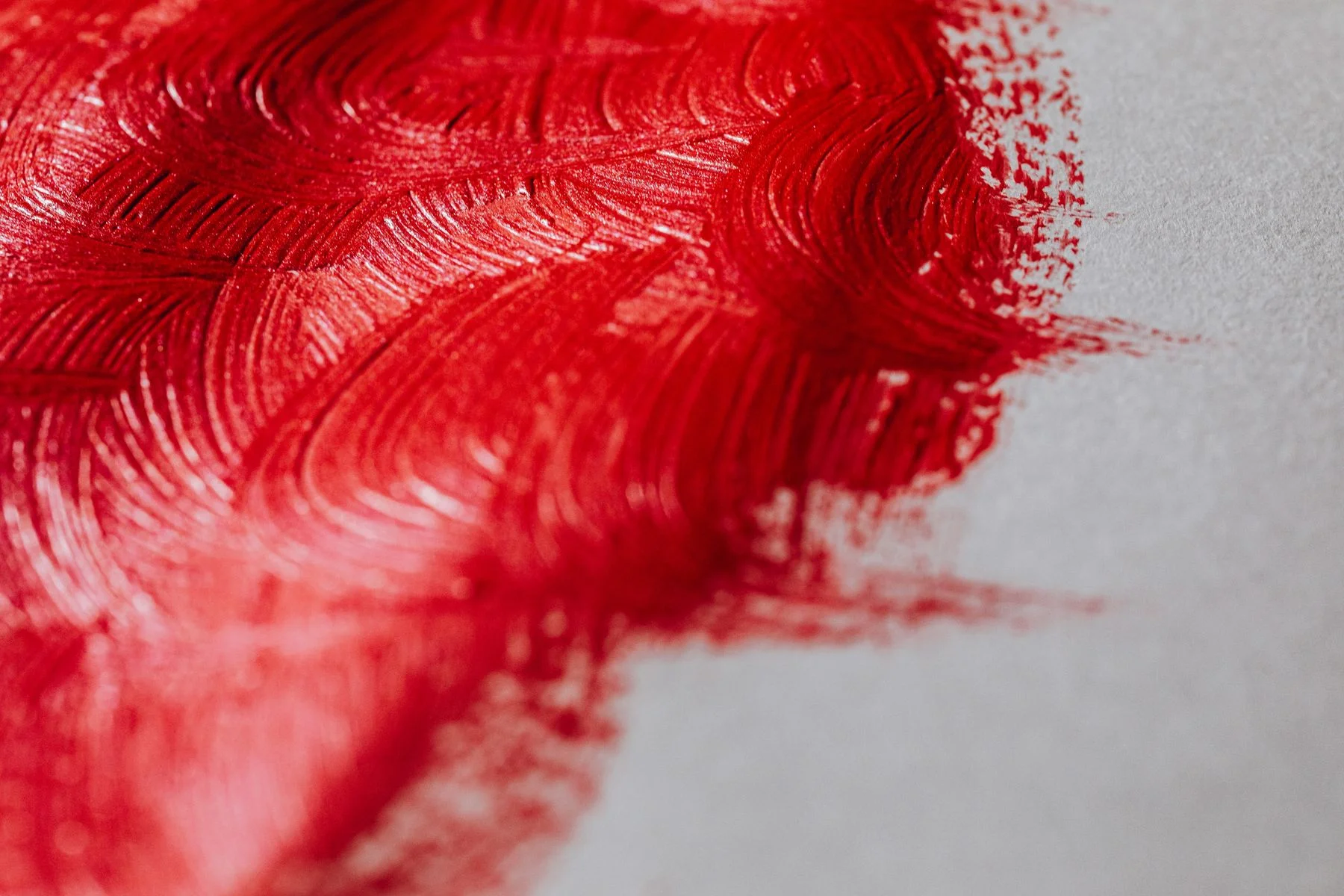 Red brushstrokes on canvas, detail