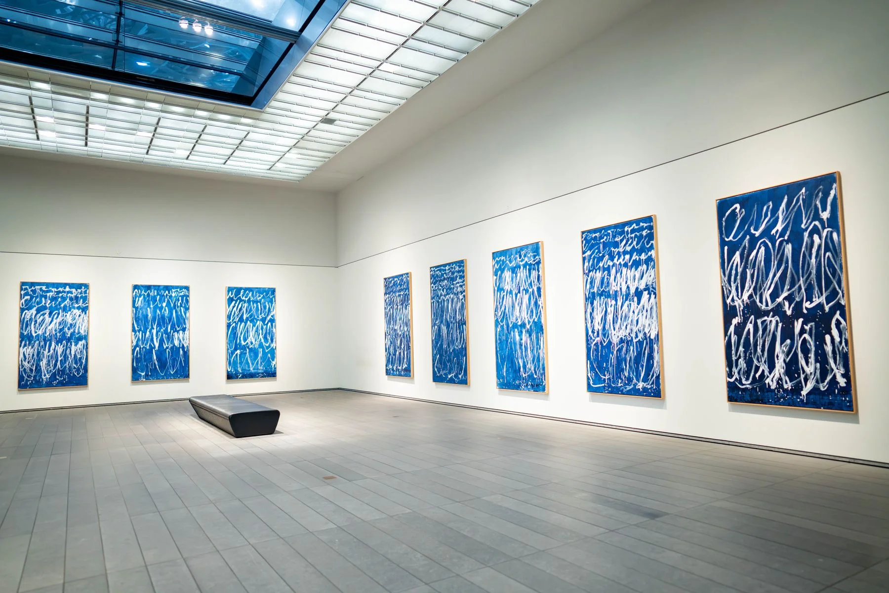 Gallery with large blue abstract paintings