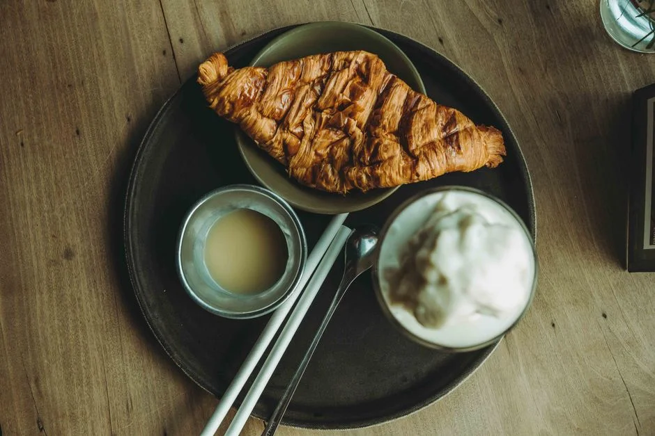 Croissants and pastries next to a cup of coffee
