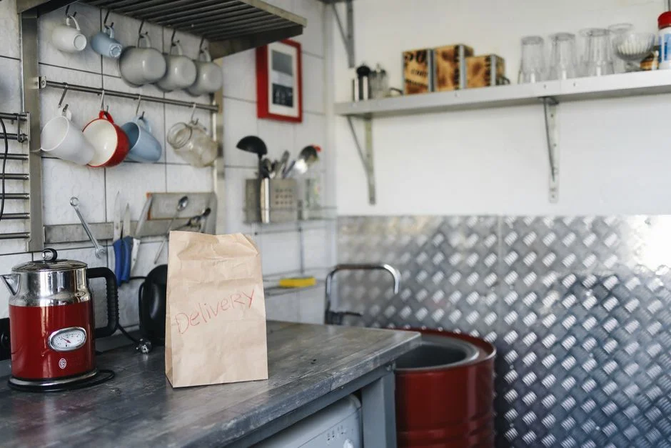 A bag of fresh coffee beans delivered to a kitchen table