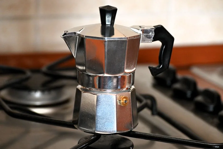 Moka pot brewing coffee on a stove