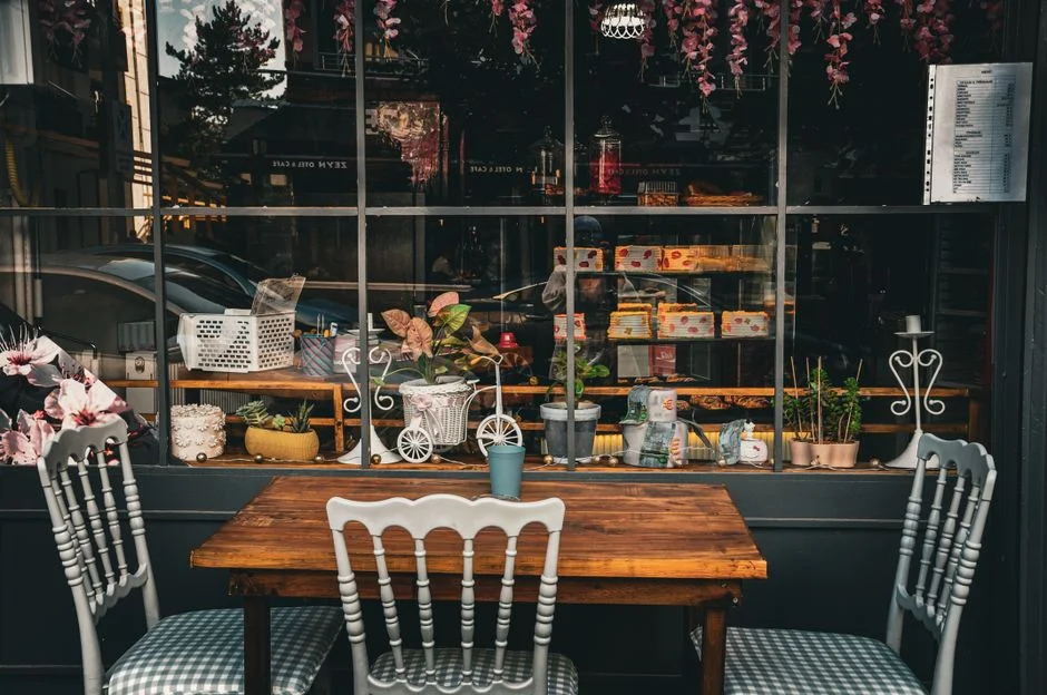 A sunny café window seat with plants