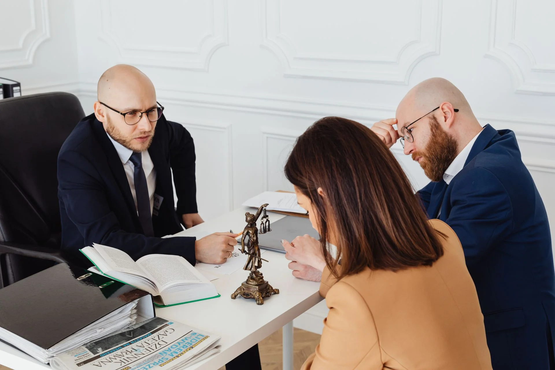 Two solicitors reviewing a financial agreement with clients
