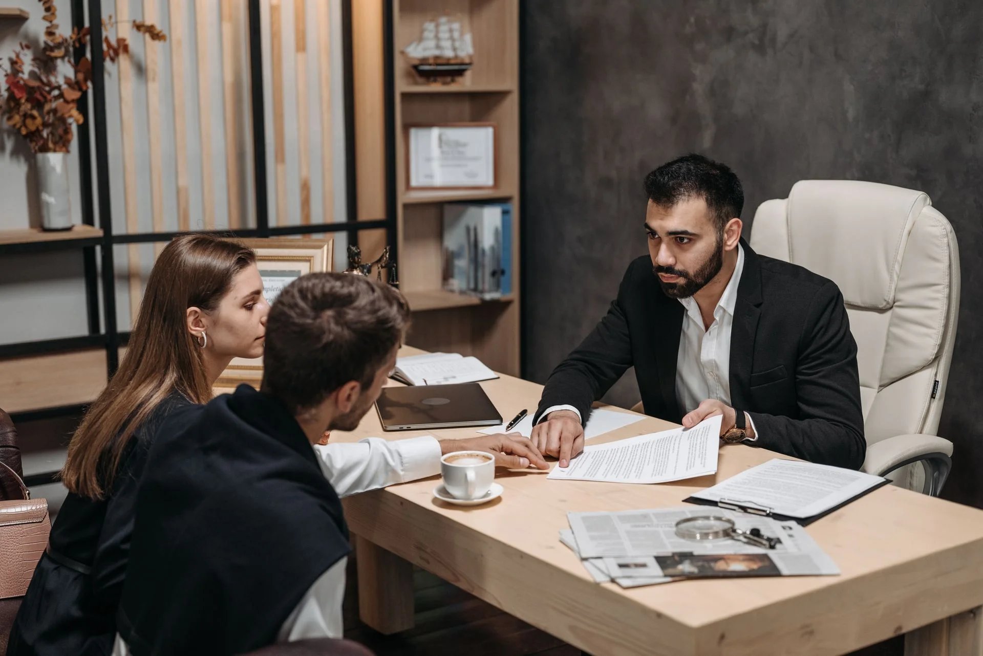 A Hart & Mercer solicitor talking through documents with a client at her desk
