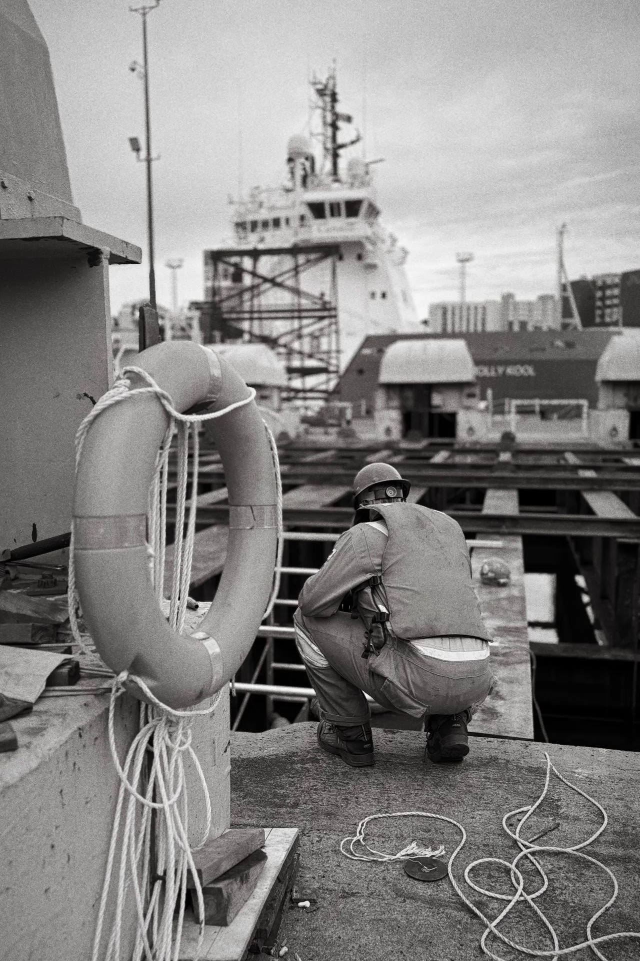 Dock worker inspecting a hull in dry dock