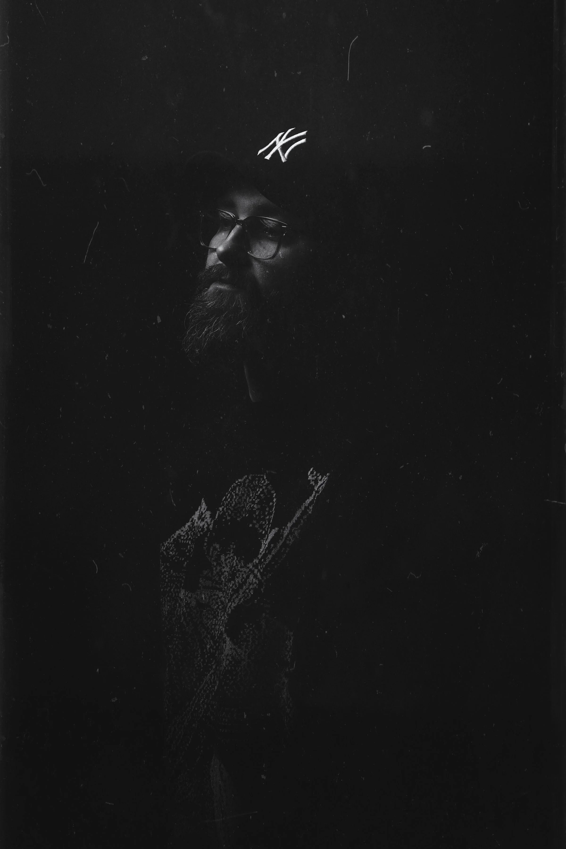 Man in a hat with a contemplative expression