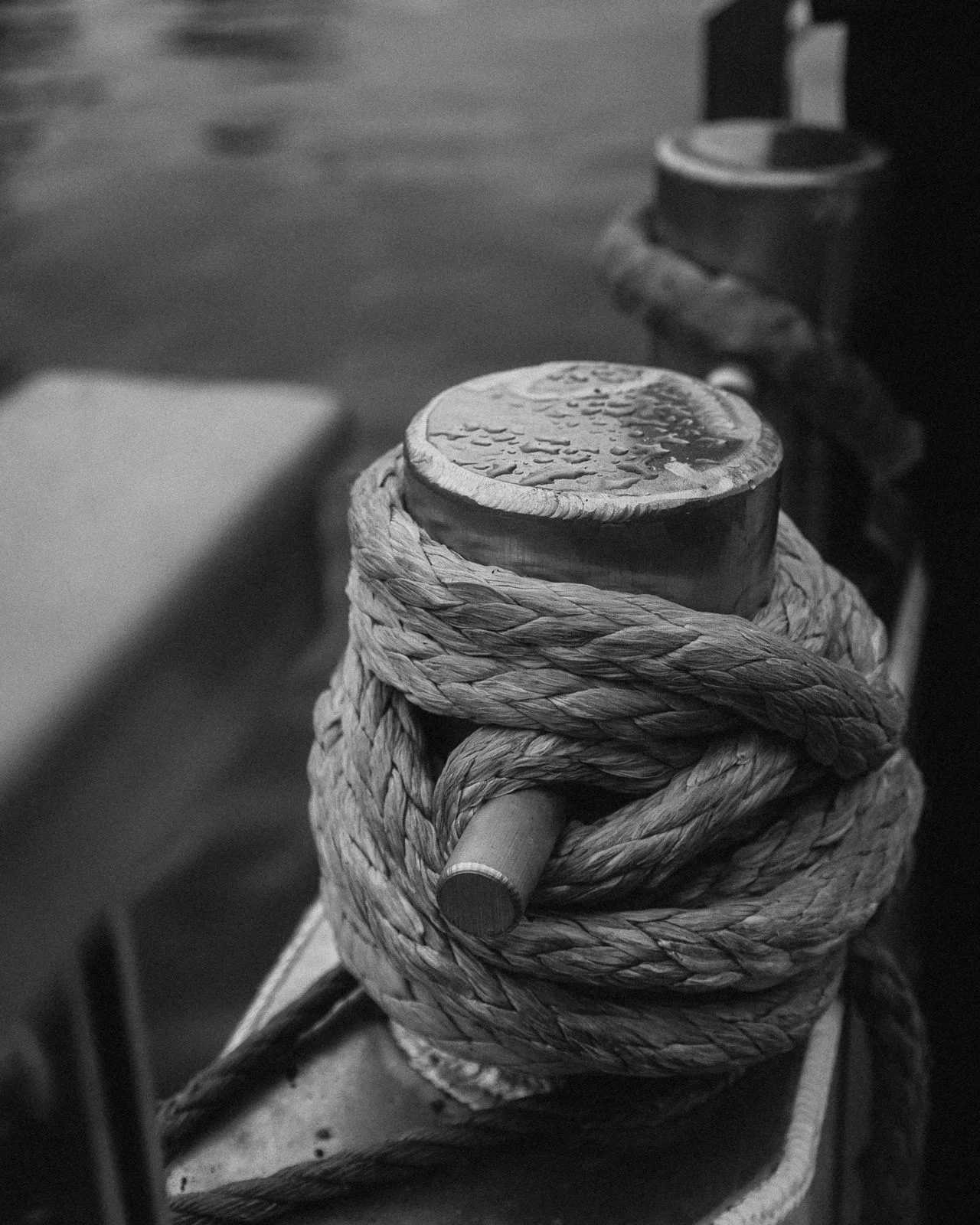 Mooring rope knotted tight around a harbour cleat