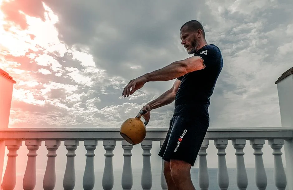 Athlete swinging a kettlebell outdoors