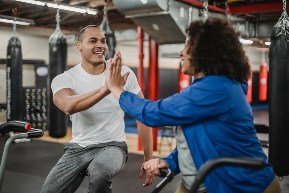 Coach and member high-fiving after a workout
