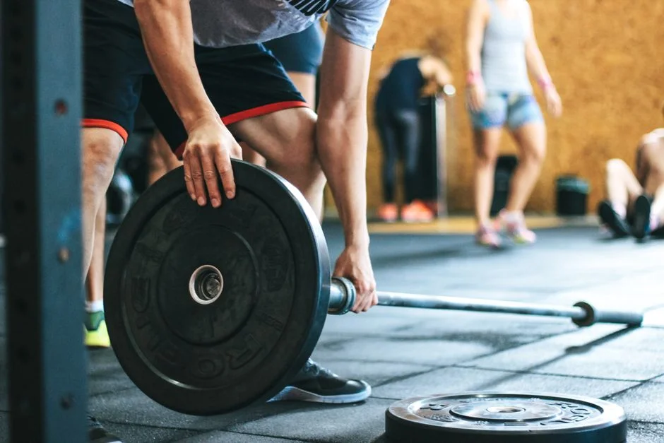 Athletes loading barbells during a Northside Athletics strength class