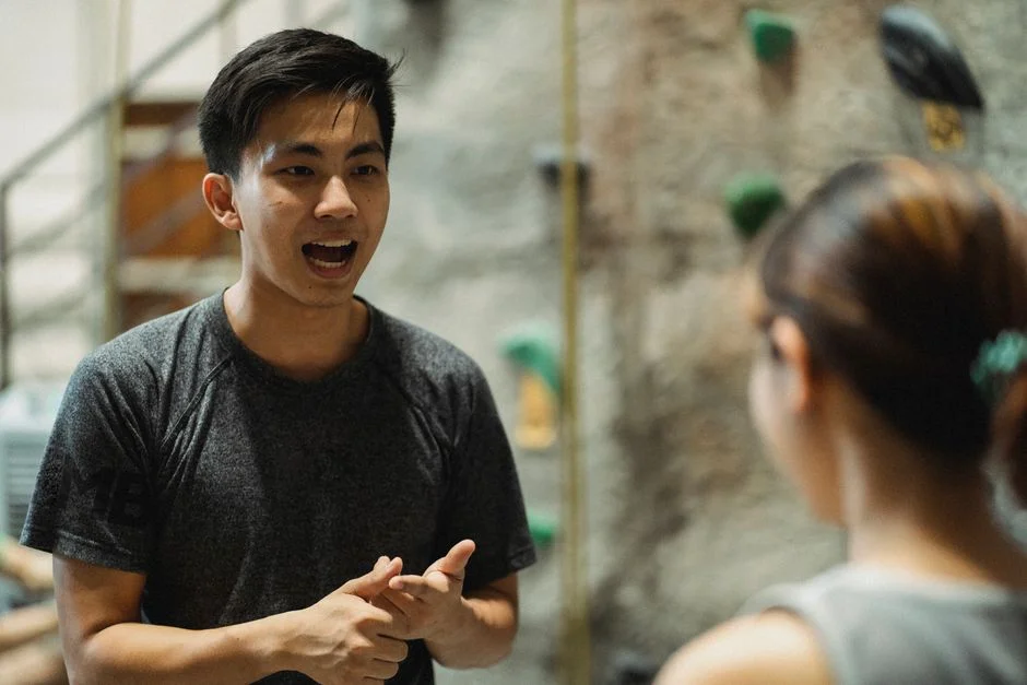 A coach explaining an exercise to a new member