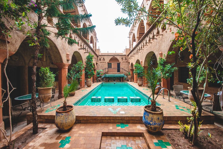 Riad courtyard lit by lanterns in the evening