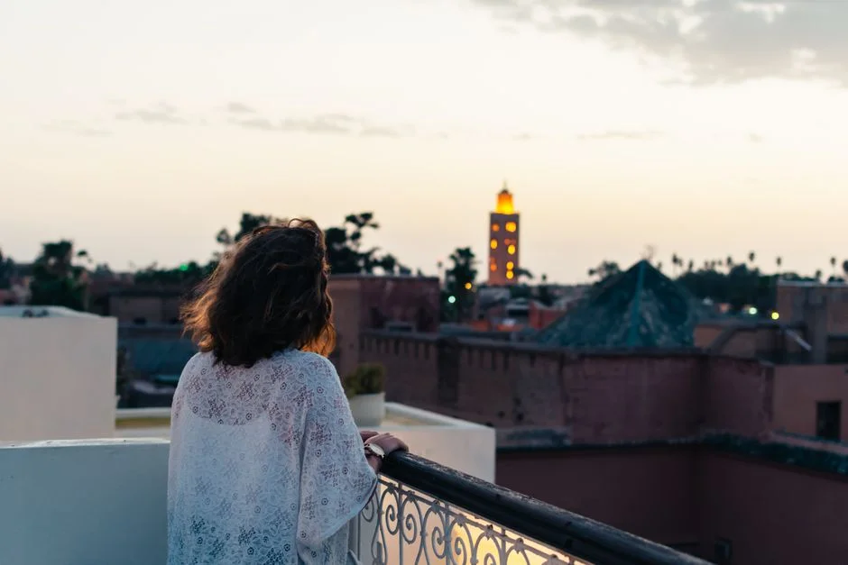 Rooftop terrace laid for dinner at dusk with lanterns