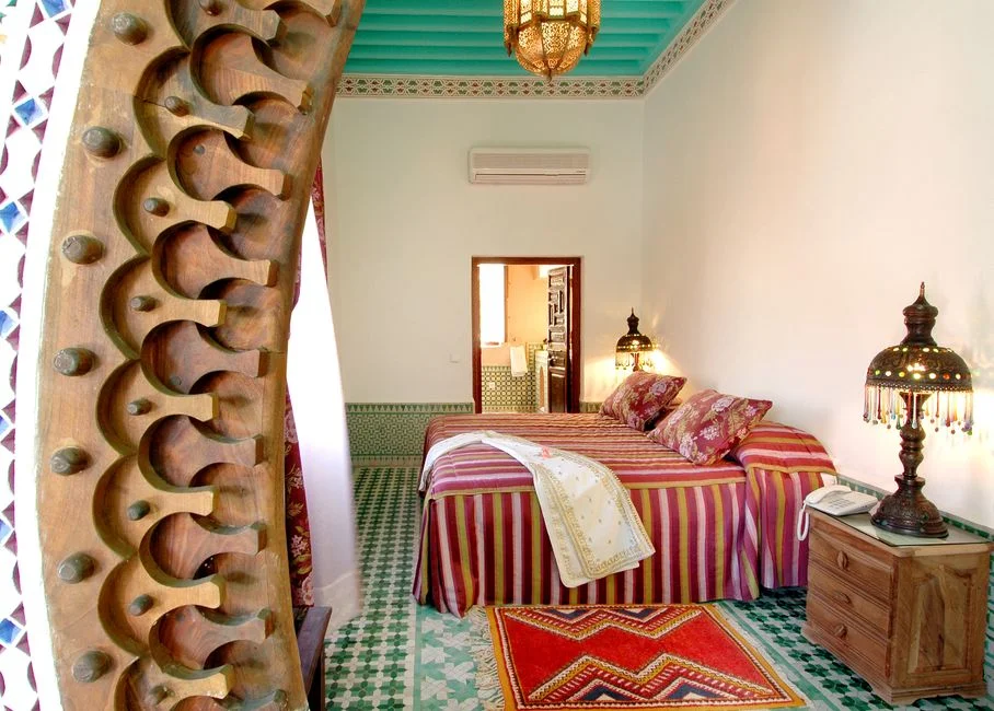 Moroccan guest room with carved wood and a lantern