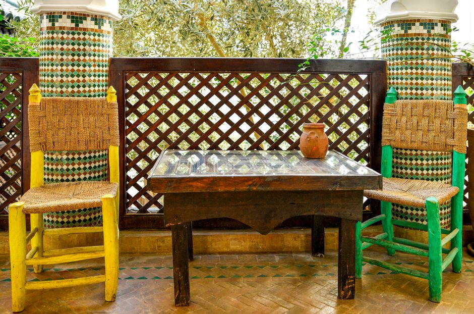 Whitewashed courtyard with zellige tiles and cedar doors