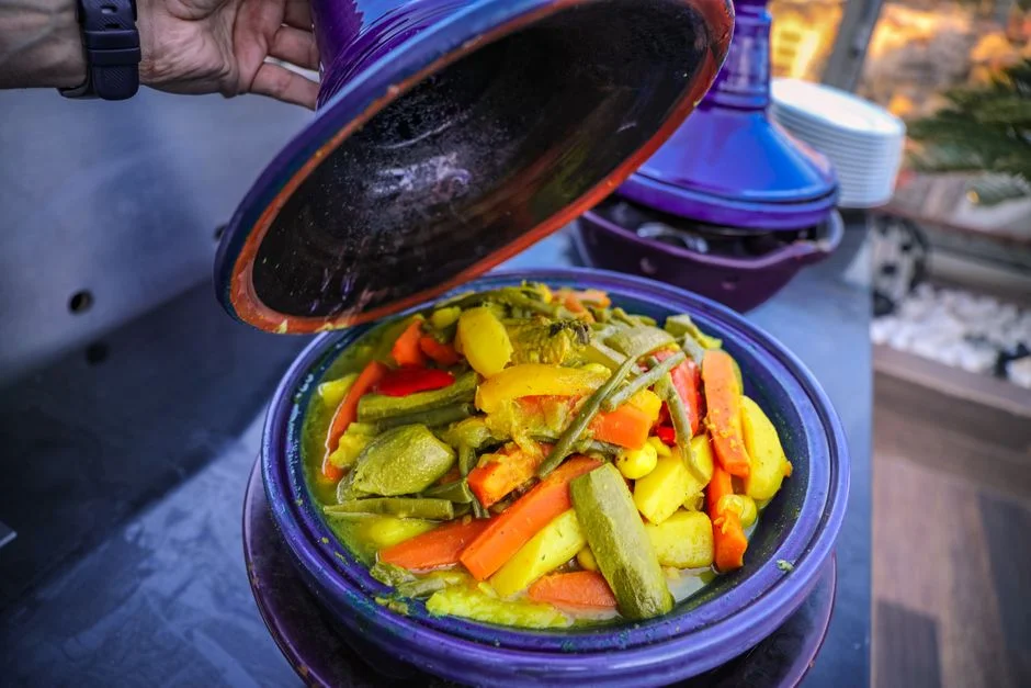 Tagine of vegetables being uncovered