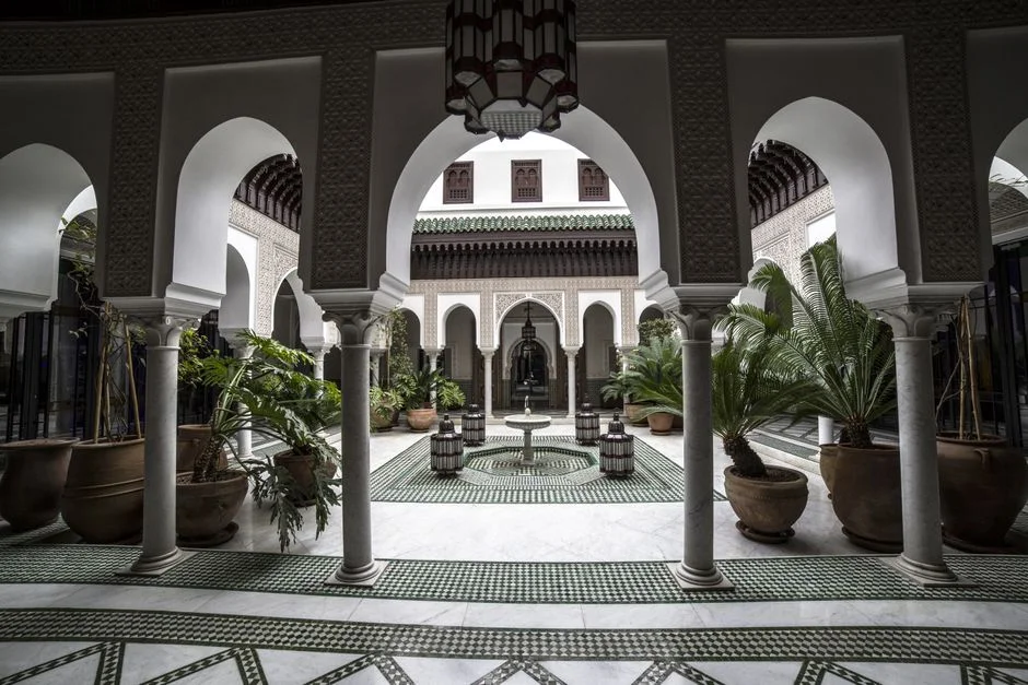 Courtyard of a Marrakech riad with a fountain and zellige tiles