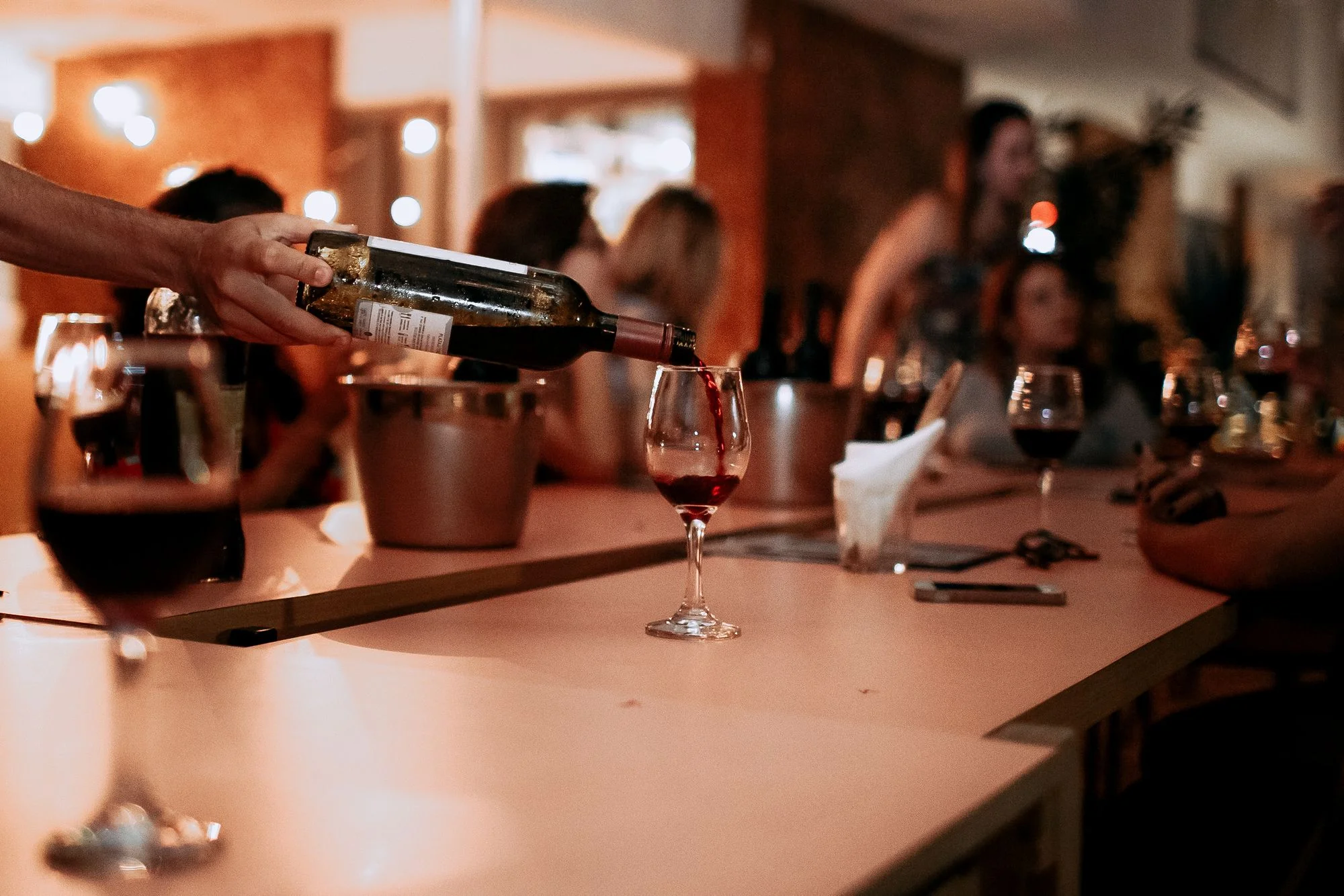 Guests sharing red wine at a Thursday tasting