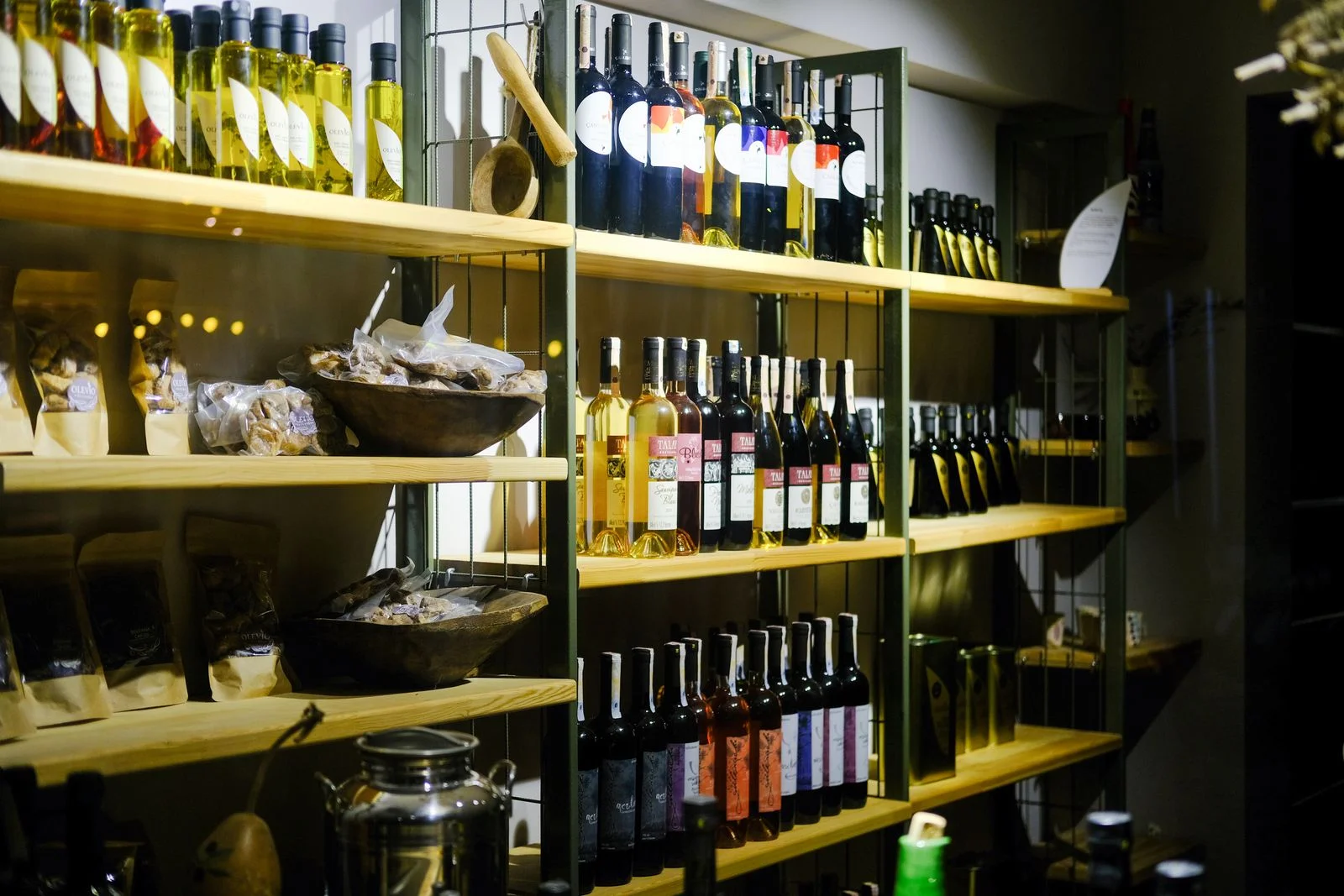 Wine bottles on wooden shelves in a small independent shop