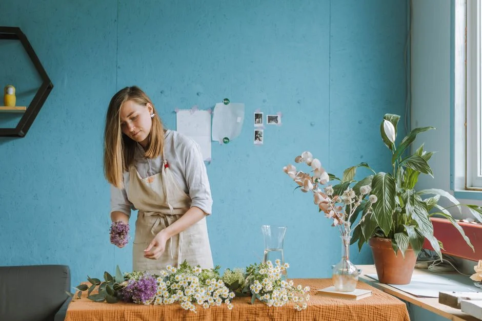 A florist arranging a loose bouquet in the Wild Stem studio
