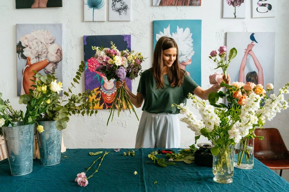 Hannah, founder of Wild Stem, holding a seasonal bouquet